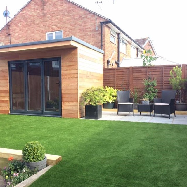 Garden with a garden room overlooking artificial grass garden